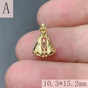 Detailed macro view of a mini 18k gold plated Virgin Mary pendant showing 10.3x15.2mm size