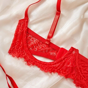Chic red lace lingerie set with eyelash trim and adjustable straps on white silk