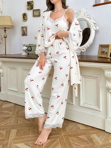 Detail of cherry print lounge set showing knit texture and delicate eyelash lace trim