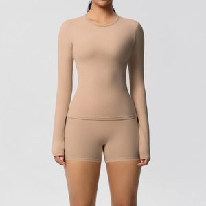 Detail of soft brushed fabric texture on seamless long-sleeve yoga top and high-waist shorts
