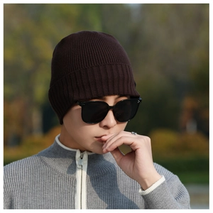 Detail of dark brown ribbed knit beanie hat showing thick texture and winter style