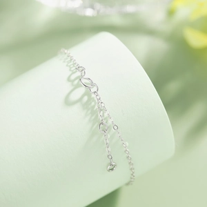 Macro view of S925 sterling silver bracelet clasp and extension chain on green stand