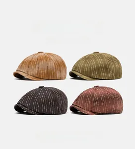 Close-up of four striped newsboy caps in retro brown, green, coffee, and red colors