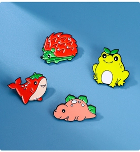 Detailed close-up of cartoon enamel pins featuring colorful animal and fruit designs