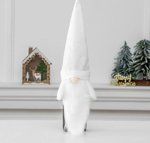 Close-up of white plush Christmas gnome wine bottle cover in a cozy Nordic setting