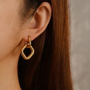 Fashion 18K gold plated stainless steel square hoop earrings with woven texture on model