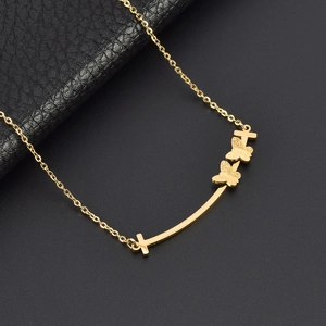 Golden titanium steel butterfly necklace with T-smile pendant on black background