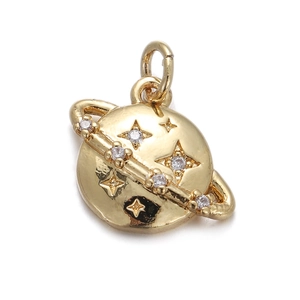 Close-up of a golden planet pendant with star relief and sparkling clear gemstones