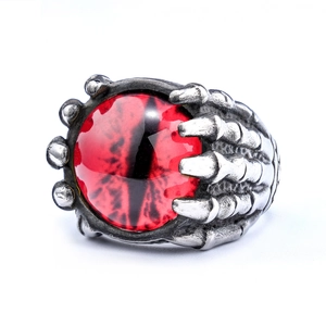Macro view of gothic punk ring featuring a red demon eye set in silver steel claws