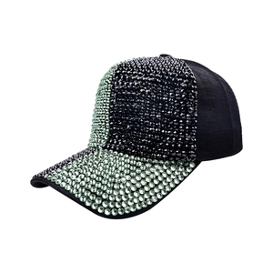 Close-up of sparkling black and light green rhinestones on the baseball cap brim