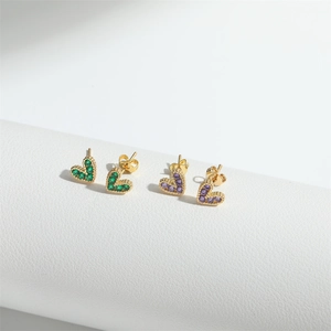Minimalist gold heart earrings set with vibrant green and purple cubic zirconia stones