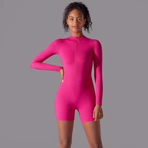 Detailed view of pink long sleeve athletic bodysuit with zip collar and elastic fabric