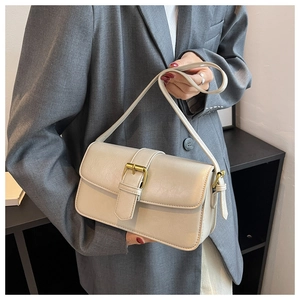 Detail of off-white retro square bag with golden buckle on a grey blazer outfit
