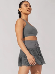 Detail of dark gray high-waisted pleated mesh skirt with drawstring for fitness women