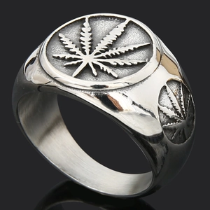 Close-up of vintage silver steel ring featuring embossed maple leaf motifs on the side