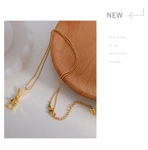 Detailed view of 18K gold plated mechanical rabbit necklace on a bead chain with extension