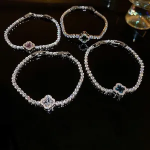 Elegant silver four-leaf clover bracelets with colorful zircon stones on black mirror
