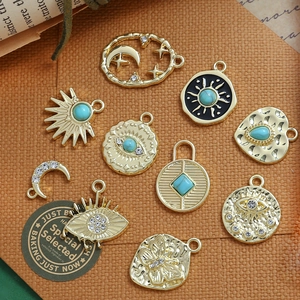Detail of assorted gold alloy pendants with bohemian celestial motifs and turquoise stones