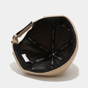 Detail of the cotton brimless dock hat showing the inner lining and washing label