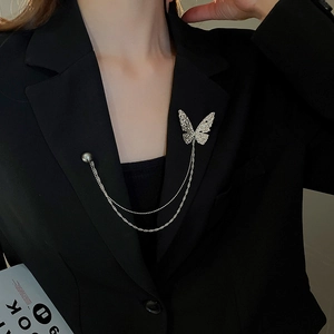 Detail of silver butterfly chain brooch with double strands on a black suit lapel