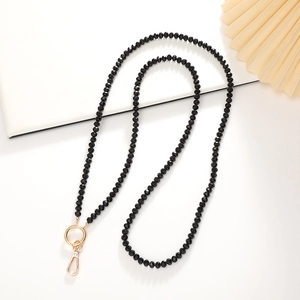 Detail view of 8mm black crystal beaded phone strap with gold spring ring and metal clasp
