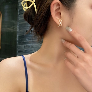 Elegant gold X-shaped cross earrings with sparkling white cubic zirconia for women