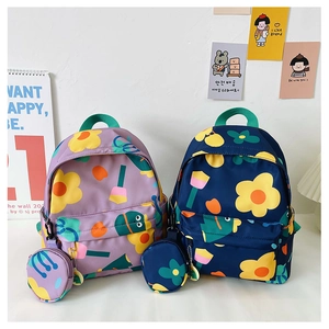 Detail of floral kids backpacks with matching round coin purse pendants and side pockets