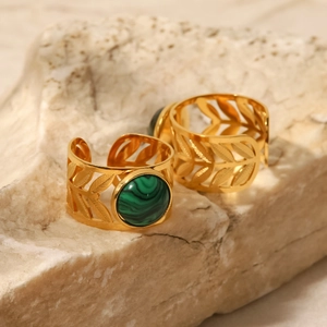 Close-up of 18K gold plated hollow leaf rings with green malachite stone on stone