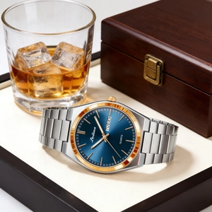 Detail of elegant men's steel watch with blue dial and dual calendar on a luxury tray