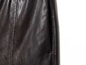 Close-up of high-waisted faux leather shorts showing pocket detail and fine stitching