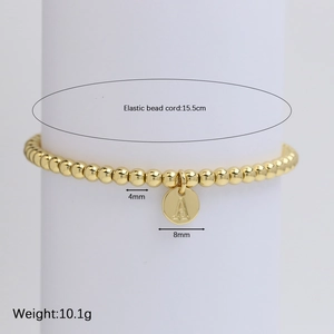 Gold beaded bracelet with letter A pendant on a minimalist 15.5cm elastic strand