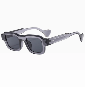 Detail view of square thick frame sunglasses with translucent grey temples and metal hinges