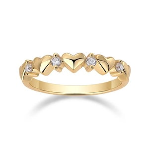 Detail shot of golden heart-shaped ring with sparkling white cubic zirconia stones
