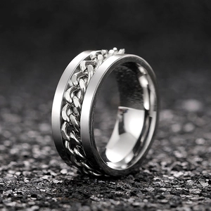 Macro shot of silver stainless steel ring featuring a rotatable Cuban link chain design