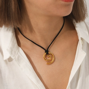 Minimalist 18K gold stainless steel spiral pendant on a black cord necklace worn by model