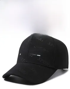 Detail of white SPORT embroidery and textured embossed lettering on black baseball cap