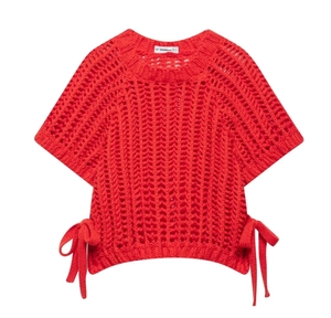 Detail of red hollow knit short sleeve top with decorative side-tie knots and patterns