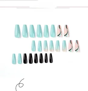 Detailed view of long coffin press on nails featuring blue and black wave art patterns