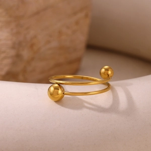 Macro shot of 18k gold plated spiral bead fidget ring with smooth polished finish