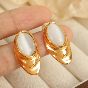 Elegant 18K gold plated oval earrings with white opal stone held by hand for size