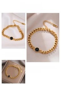 Detail of 18K gold plated punk chain bracelet featuring a round black gemstone inlay