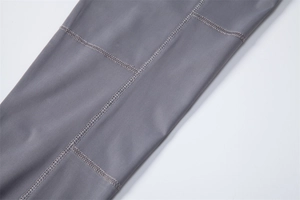 Macro shot of grey fabric texture and reinforced stitching on UV protective shirt