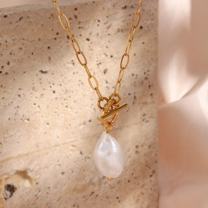 Detail of baroque freshwater pearl necklace with golden OT clasp and paperclip chain