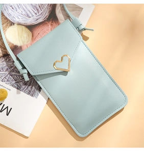 Close-up of light blue PU leather phone bag with a gold heart-shaped buckle detail