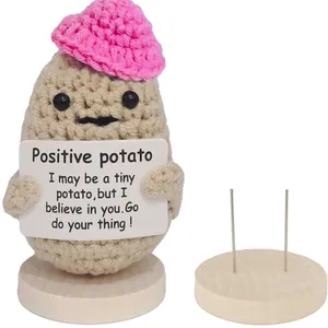 Handmade crochet positive potato doll with pink hat and wooden stand for home decor