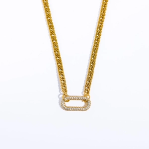 Close-up of gold chunky Cuban chain choker with sparkling rhinestone oval clasp detail