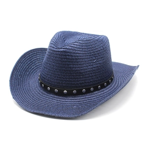 Detailed close-up of dark blue woven straw hat with silver studded black band accent