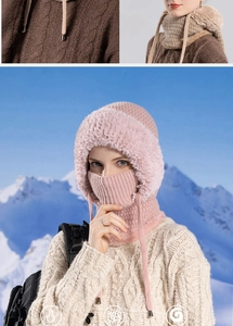Detail of pink and brown fleece-lined knitted hats with neck warmer in the snow