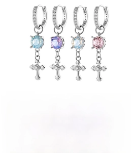 Detail of iris cross pendant earrings in four colors made of copper and cubic zirconia