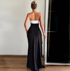 Rear view of a black and white off-the-shoulder maxi dress with a high-waisted split design